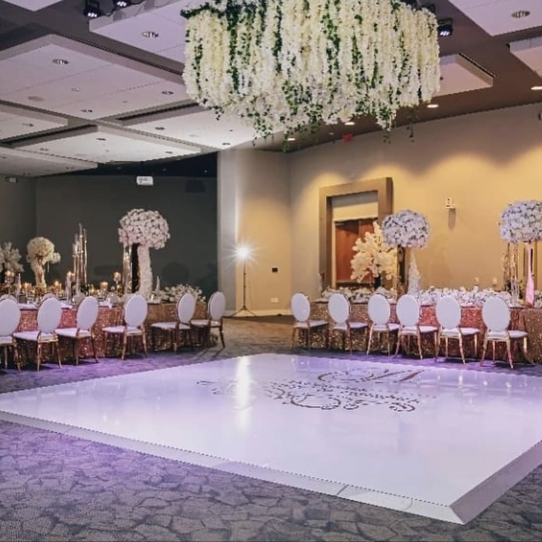 Wide reception room with dance floor and hanging florals